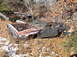 1974 Dodge Challenger - Two derelict vehicles sit abandoned in a wooded area, covered in leaves and snow.