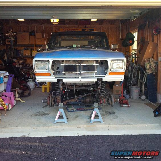 1978 Ford Bronco front end on jack stands in garage