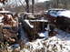 1974 Dodge Challenger - Abandoned 1974 Dodge Challenger sits in a snowy junkyard, its interior and engine bay exposed and rusted.