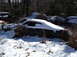 1974 Dodge Challenger - A car sits partially covered in snow, with another vehicle visible in the background.