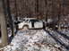 1974 Dodge Challenger - Abandoned white car in a snowy forest setting, showing significant front-end damage.