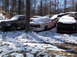 1974 Dodge Challenger - A collection of vehicles sits covered in snow in a junkyard setting.