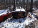 1974 Dodge Challenger - Two cars sit abandoned in a snowy junkyard, with the rear of a black Dodge GT visible.