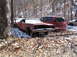 1974 Dodge Challenger - An old, weathered muscle car sits abandoned in a snowy wooded area next to a red minivan.