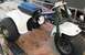 1900 Honda Big Red - This three-wheeled ATV is white with a black seat and green front forks.
