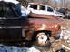 1974 Dodge Challenger - A weathered vehicle sits in a yard, with another car partially visible behind it.