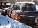 1974 Dodge Challenger - A 1974 Dodge Challenger sits partially covered in snow, viewed from the front three-quarter angle.