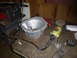 1953 Plymouth Belvedere - A workbench displays a transmission bell housing next to an angle grinder and other automotive parts.