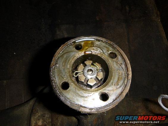 close-up of a driveshaft U-joint with a cotter pin and nut