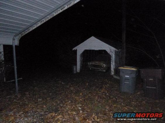 1953 Plymouth Belvedere parked in a carport at night, front view