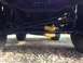 1979 Ford Bronco - Close-up of the steering and suspension system, showing yellow bellows on tie rods.