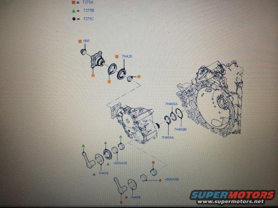 Diagram of drivetrain components including a transfer case, seals, and shafts