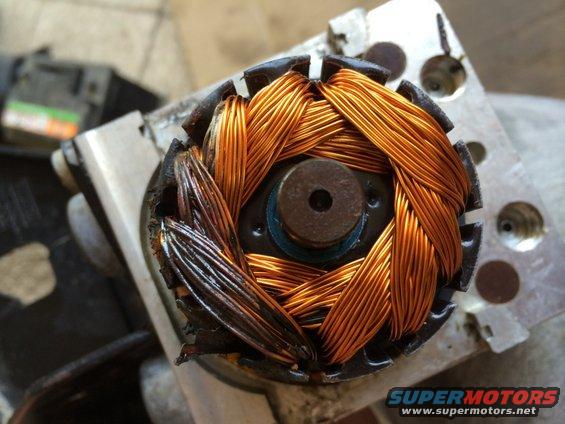 Electric motor rotor showing copper windings, some of which are burnt