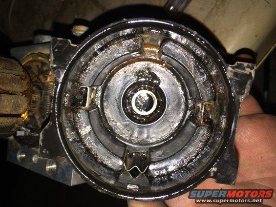 Close-up of a greasy automotive part with a bearing