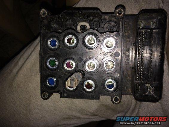 ABS control module with multiple circular connectors and a large electrical connector