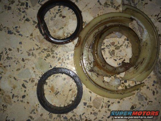 worn seals and a broken plastic ring on a tiled surface