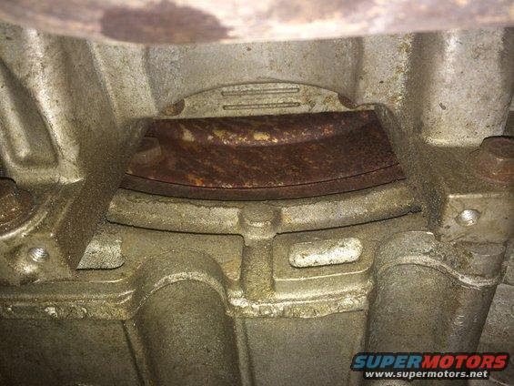 Close-up of rusty metal components and bolts on a vehicle's underside