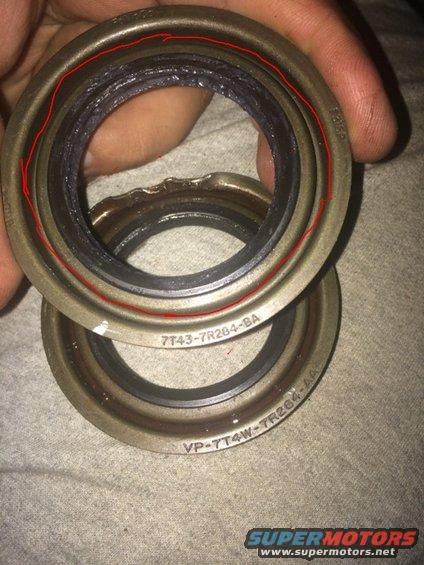 Two metal seals, one with red lines, the other with part numbers 7T43-7R284-BA and VP-7T4W-TR284-AA
