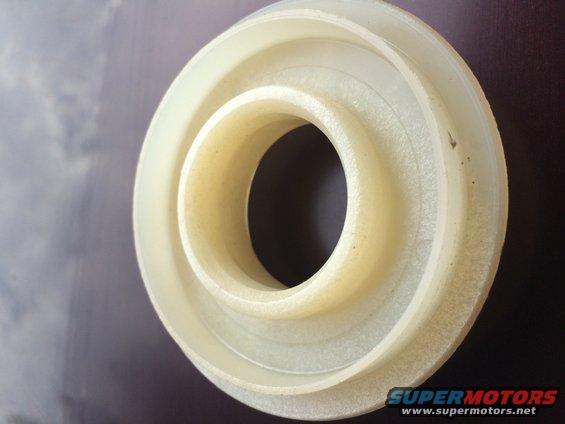 Close-up of a white plastic bearing or seal with concentric rings