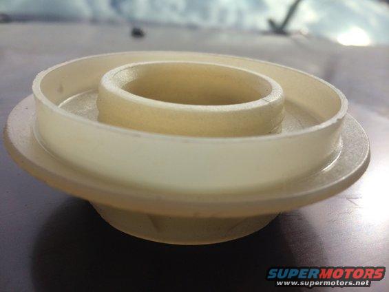 Close-up of a beige plastic automotive part with concentric rings