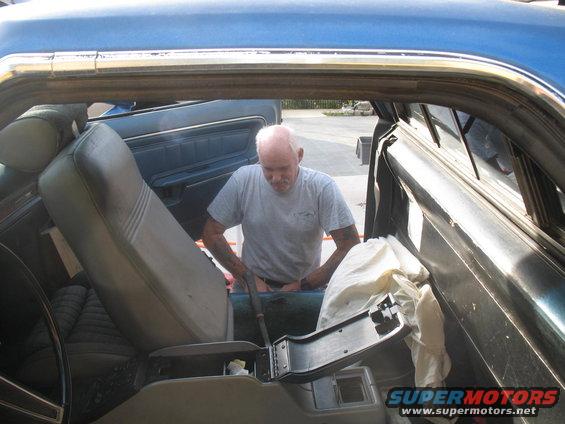 guy getting into the passenger side of a car