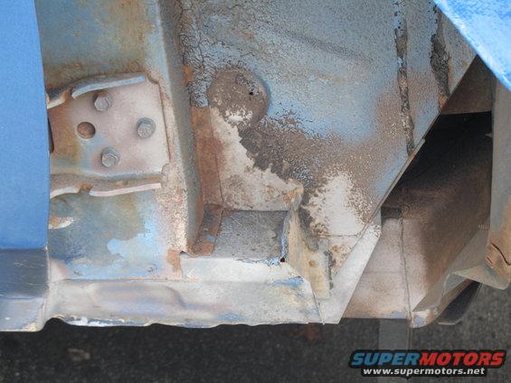 rusted metal frame and body panel, blue paint