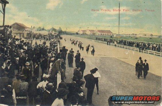 Horse race at a state fair with crowds watching from the stands and trackside