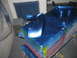 1972 Ford Ranchero - Car parts are being prepped and painted in a workshop.