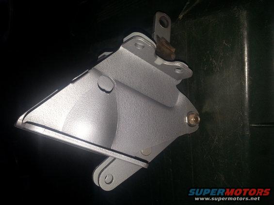 Silver metal bracket with bolt and pivot points, against a dark background
