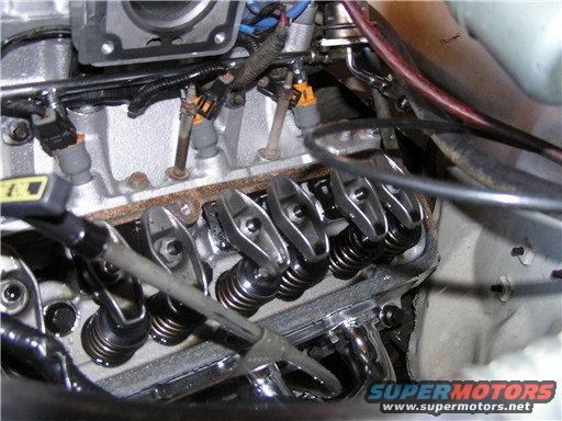 Close-up of engine valve train with rocker arms and springs visible