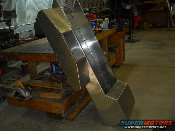 Metal fabrication project on a workbench with tools