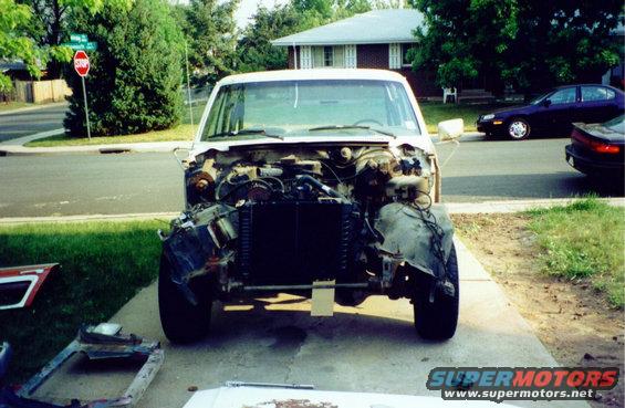 White 1981 Ford Bronco front end disassembled, showing engine and radiator