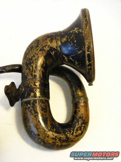 Antique black and gold vehicle horn with worn patina