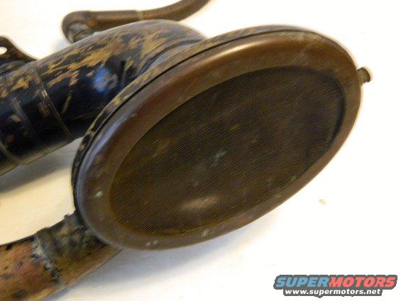 Close-up of an old car horn with a mesh screen