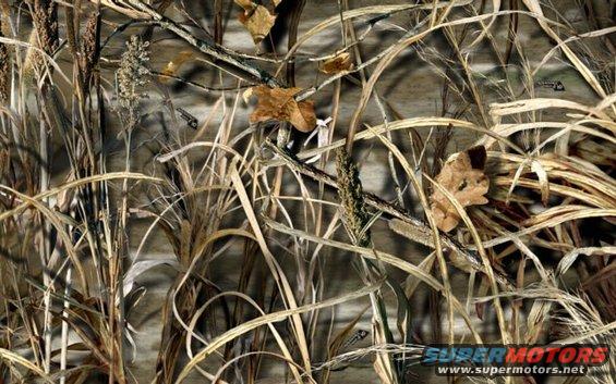 Camouflage pattern with reeds and leaves. Supermotors.net logo at bottom right