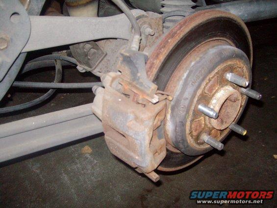 tire002.jpg Factory rear brakes.  Definately time for some upgrades.  Calipers will get an upgrade as well.