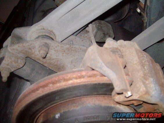 Lower view of control arms, rotor and caliper.