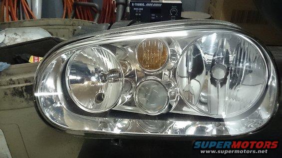 Headlight assembly with chrome trim and amber turn signal