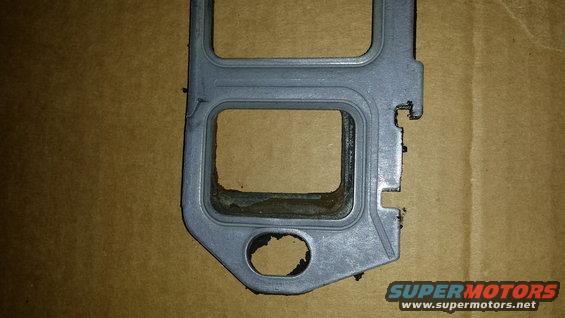 Engine gasket with two rectangular openings and one circular hole