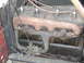 1913 Ford Model T - Close-up view of a 1913 Ford Model T engine, showing the exhaust manifold, carburetor, and spark plug wires.