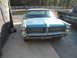 1972 Ford Ranchero - Front view of a blue 1963 Pontiac Bonneville, a prominent chrome grille and stacked headlights, parked next to a pickup truck.