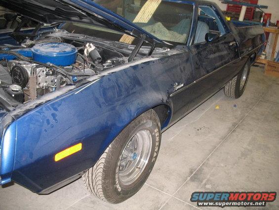Blue 1972 Ford Ranchero with hood open, showing engine and front fender