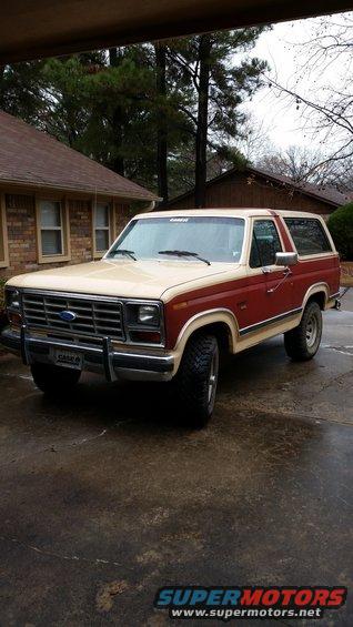 Two-tone red and tan Ford Bronco parked in a driveway