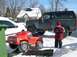 1986 Ford Bronco - A child stands next to a Ford Bronco and a toy truck in a snowy yard.