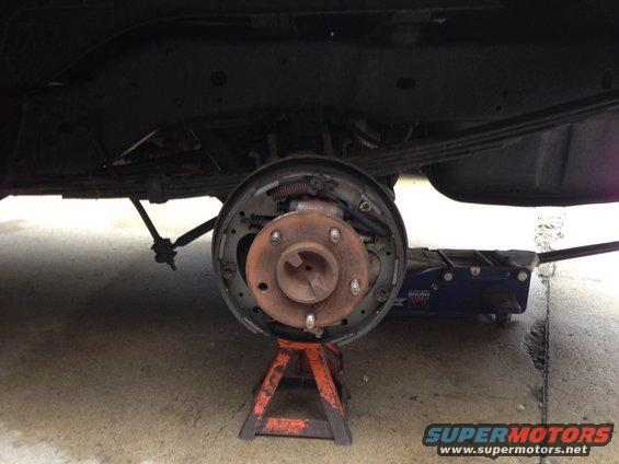 img_1810.jpg Adjusting rear brakes.  Oh, and I busted a lug stud.  