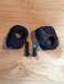 1995 Ford Bronco - Two rubber body mounts and two bolts are laid out on a wooden surface.
