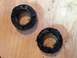 1995 Ford Bronco - Two worn bearing seals are shown on a wooden surface, indicating a need for replacement.