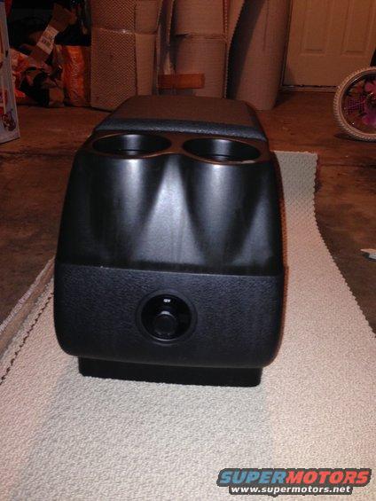 center console with two cup holders and a dial control