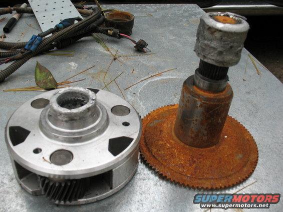 Worn metal gear and shaft assembly with wiring harness in background