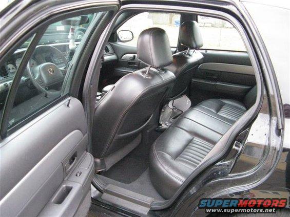 2003 Mercury Marauder interior showing front and rear black leather seats, dashboard, and door panels